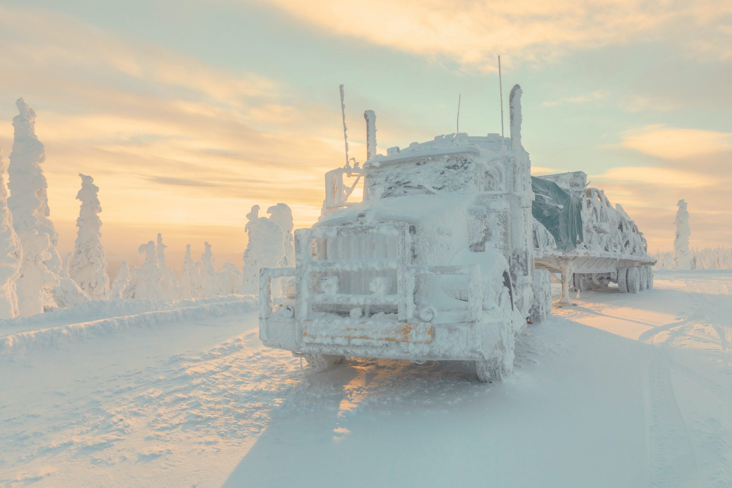 Snow-covered freight truck in extreme winter conditions representing Plexus Freight's all-weather road freight capability