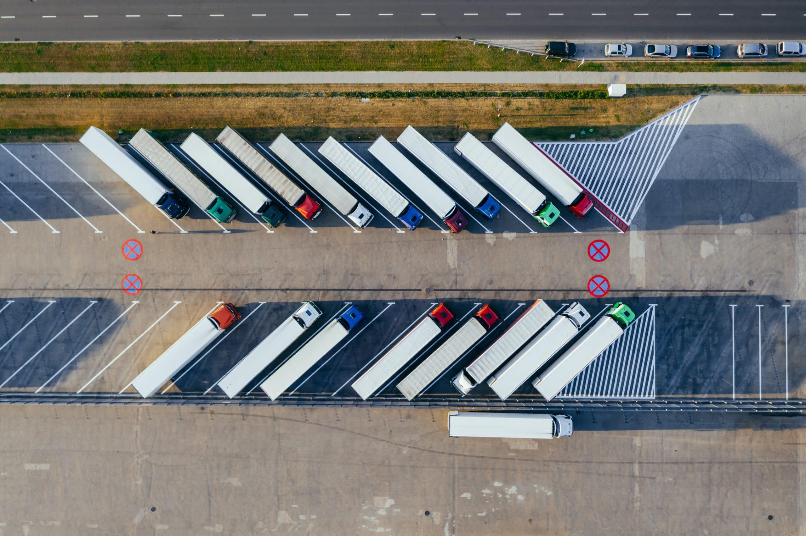 Aerial view of HGV truck fleet parked at freight depot representing Plexus Freight's road freight operations