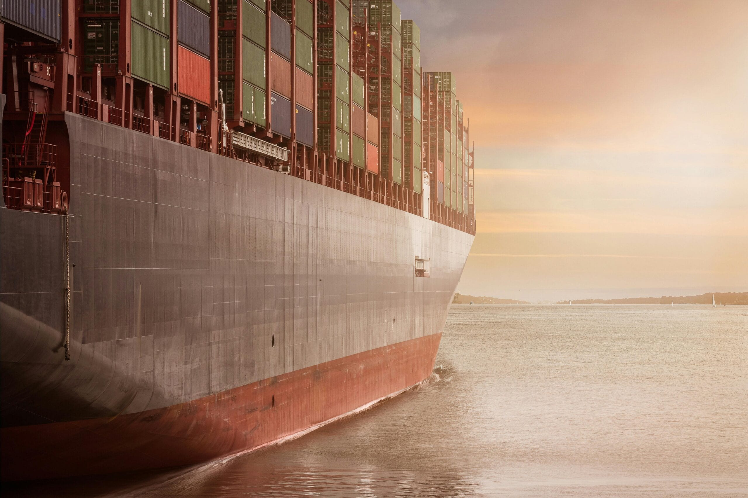 Large container ship loaded with shipping containers at sea representing Plexus Freight's sea freight services