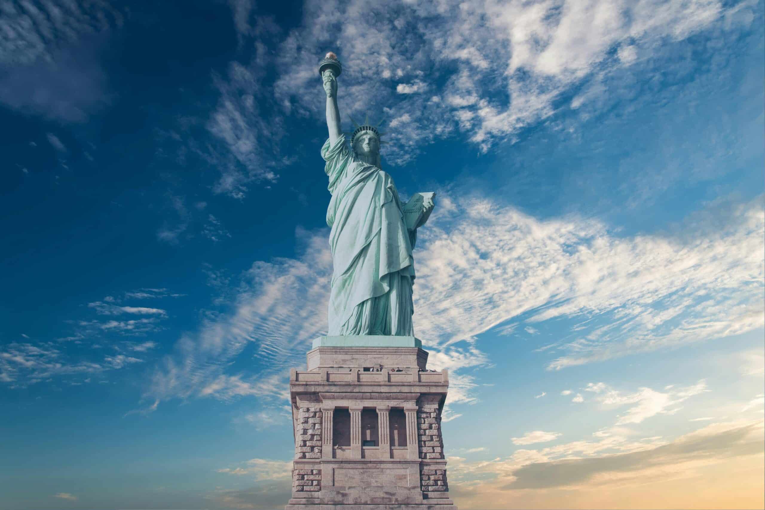 Statue of Liberty against a blue sky representing Plexus Freight's freight forwarding services to the USA