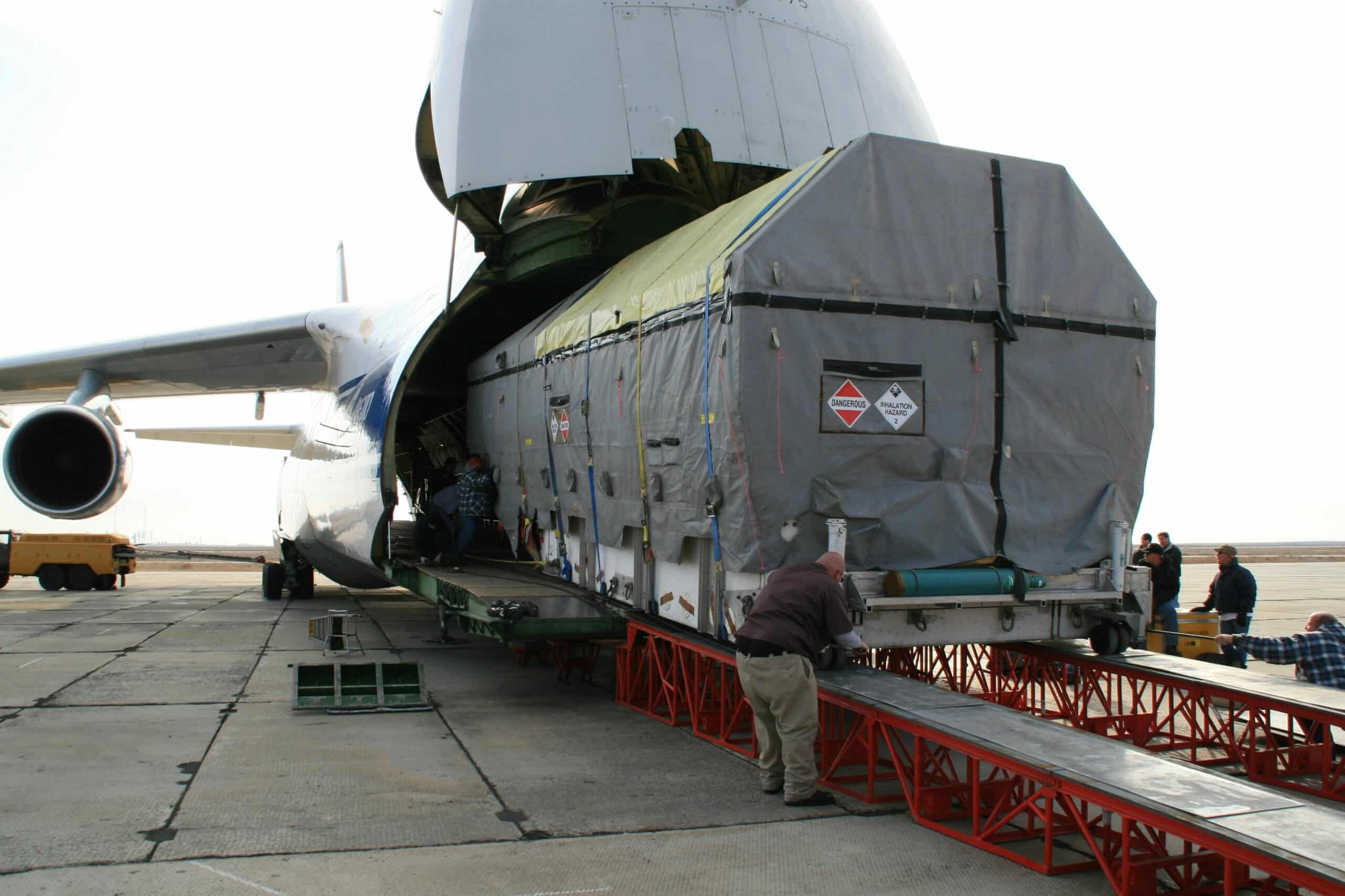 Oversized cargo being loaded into a wide-body freighter aircraft representing Plexus Freight's air freight services