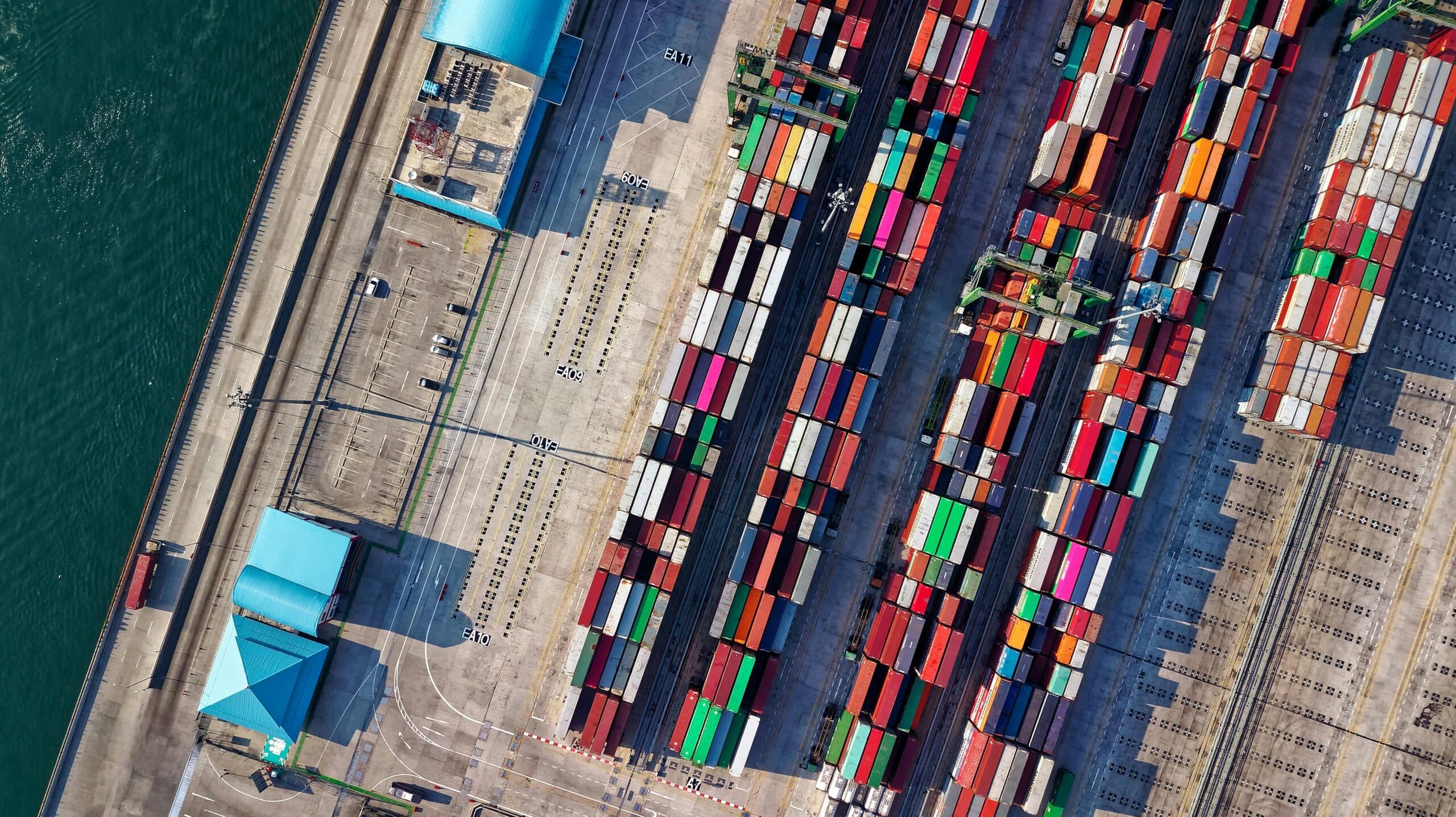 Aerial view of colourful shipping containers stacked at port yard representing Plexus Freight's sea freight operations