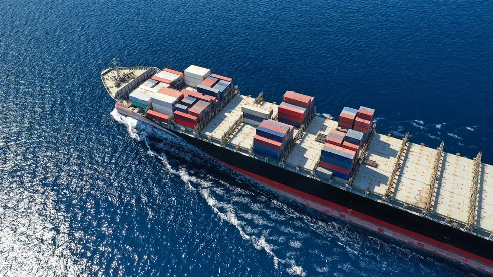 Cargo container ship at sea representing Plexus Freight's international sea freight services